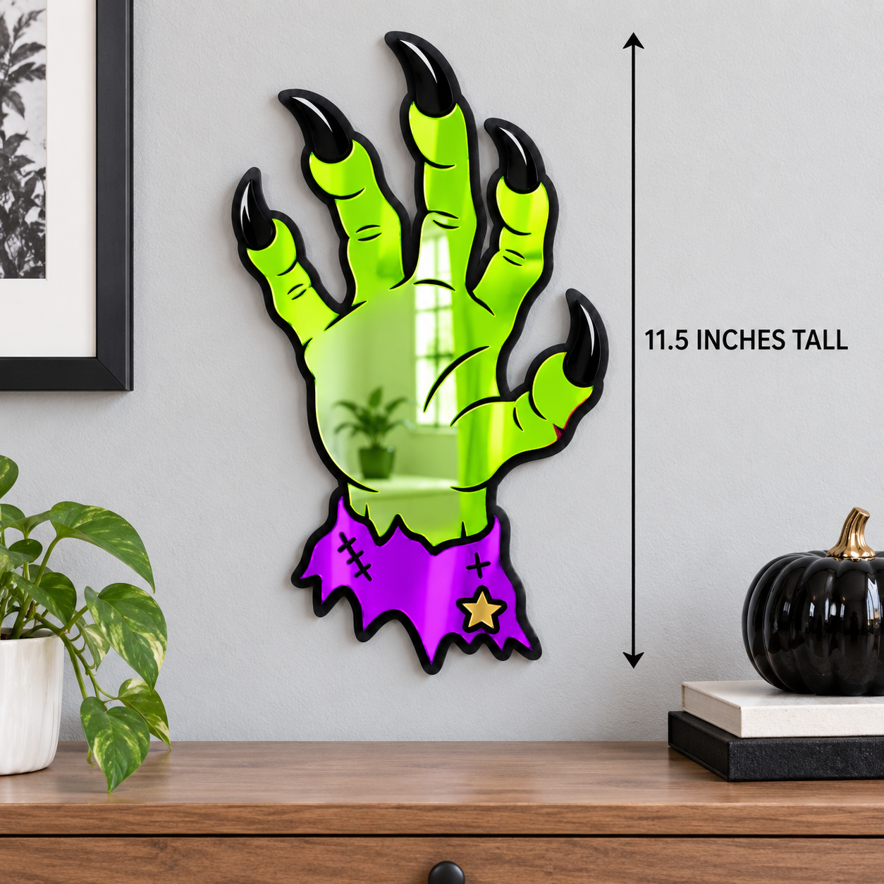 Neon-green monster hand wall mirror measuring 11.5 inches tall