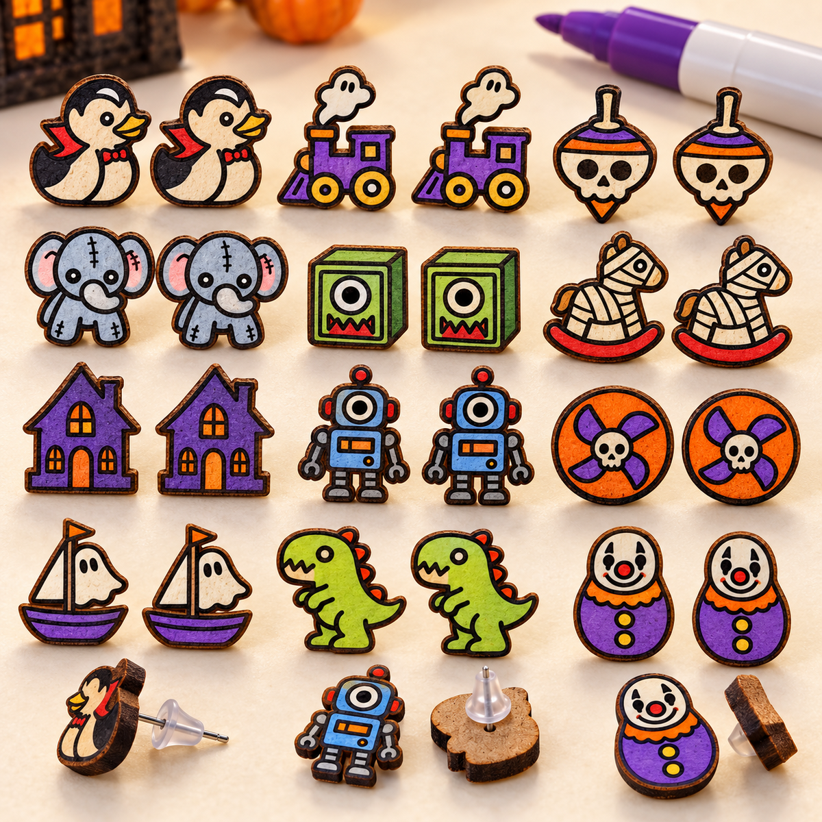 Painted Cursed Toybox horror stud earrings displayed with visible post earring backs