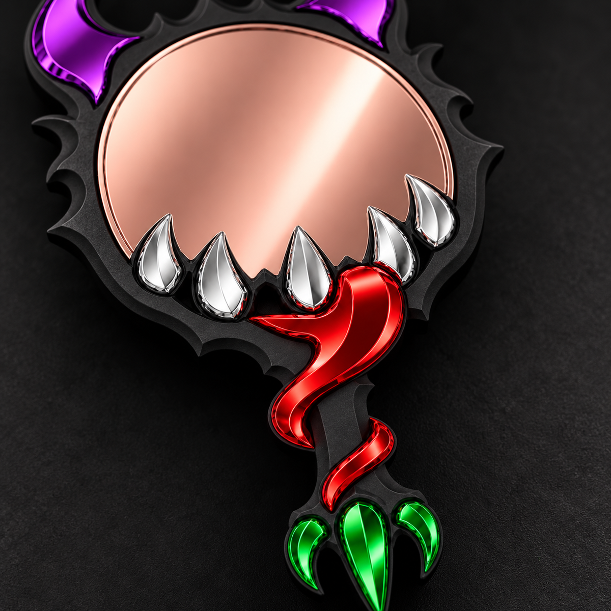 A monster-themed hand mirror with a black frame, metallic rose gold reflective surface, silver teeth, purple horns, a red tail, and green claws on a dark background.
