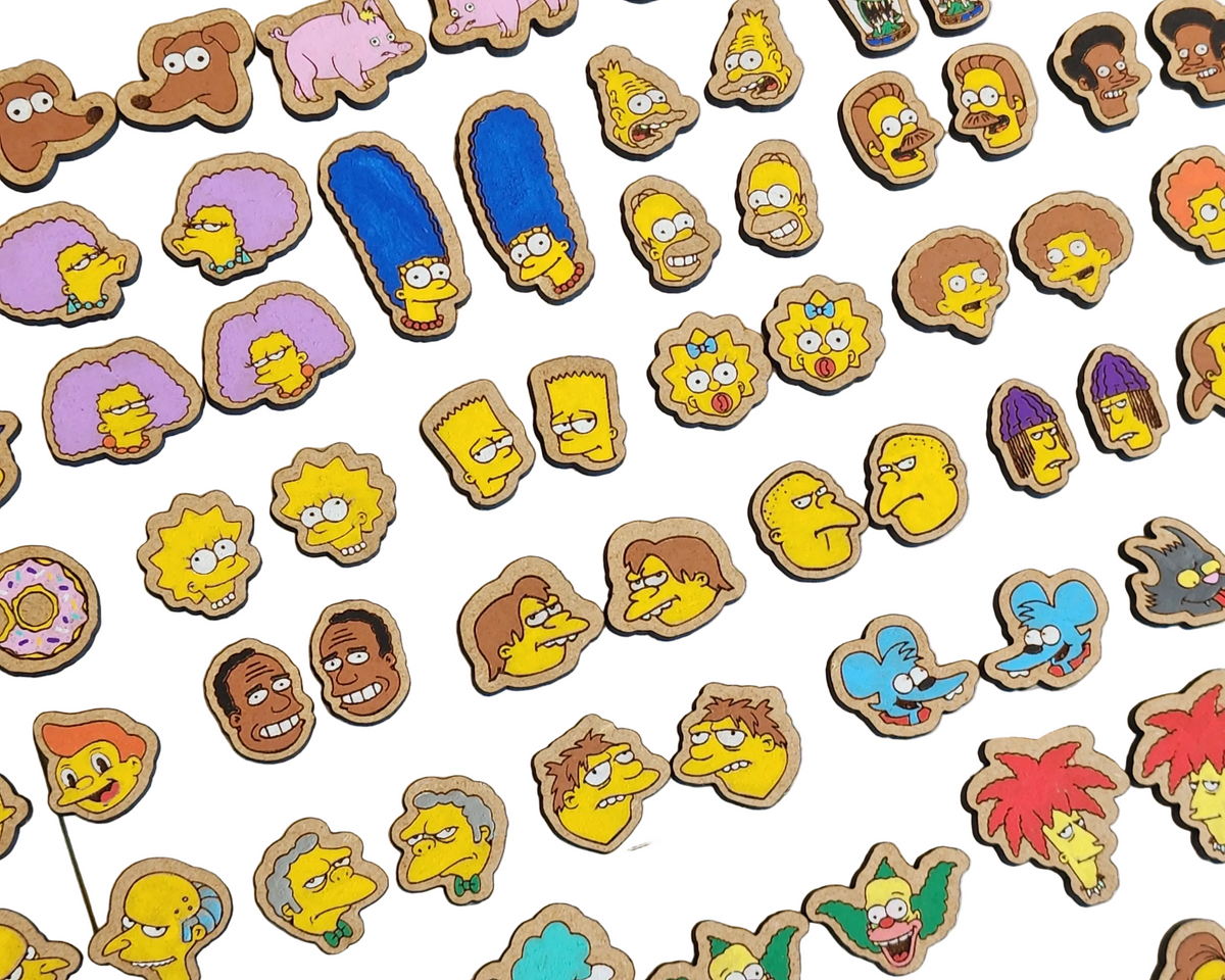 A collection of various Simpson's character-themed earrings laid out on a surface.